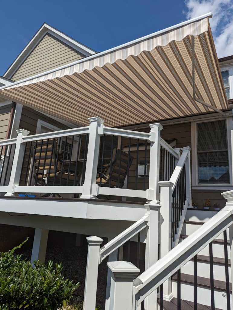 deck with retractable awning over an outdoor dining table.