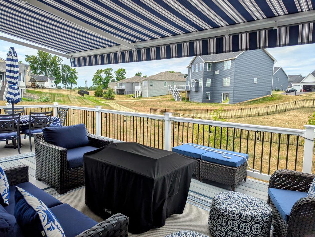 deck with blue and white striped retractable awning