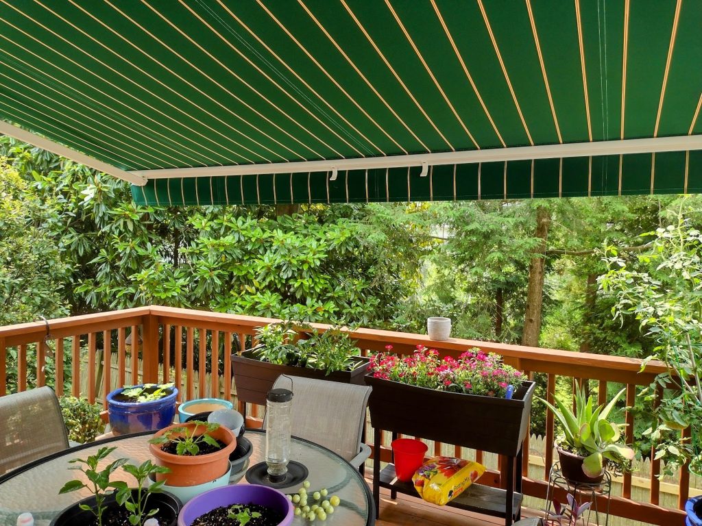 deck with green and yellow stripes awning