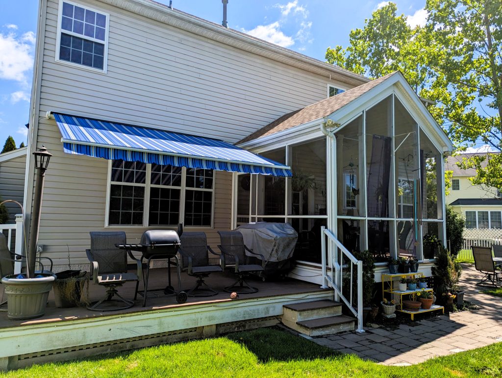 outdoor living space with screened in porch and blue awning